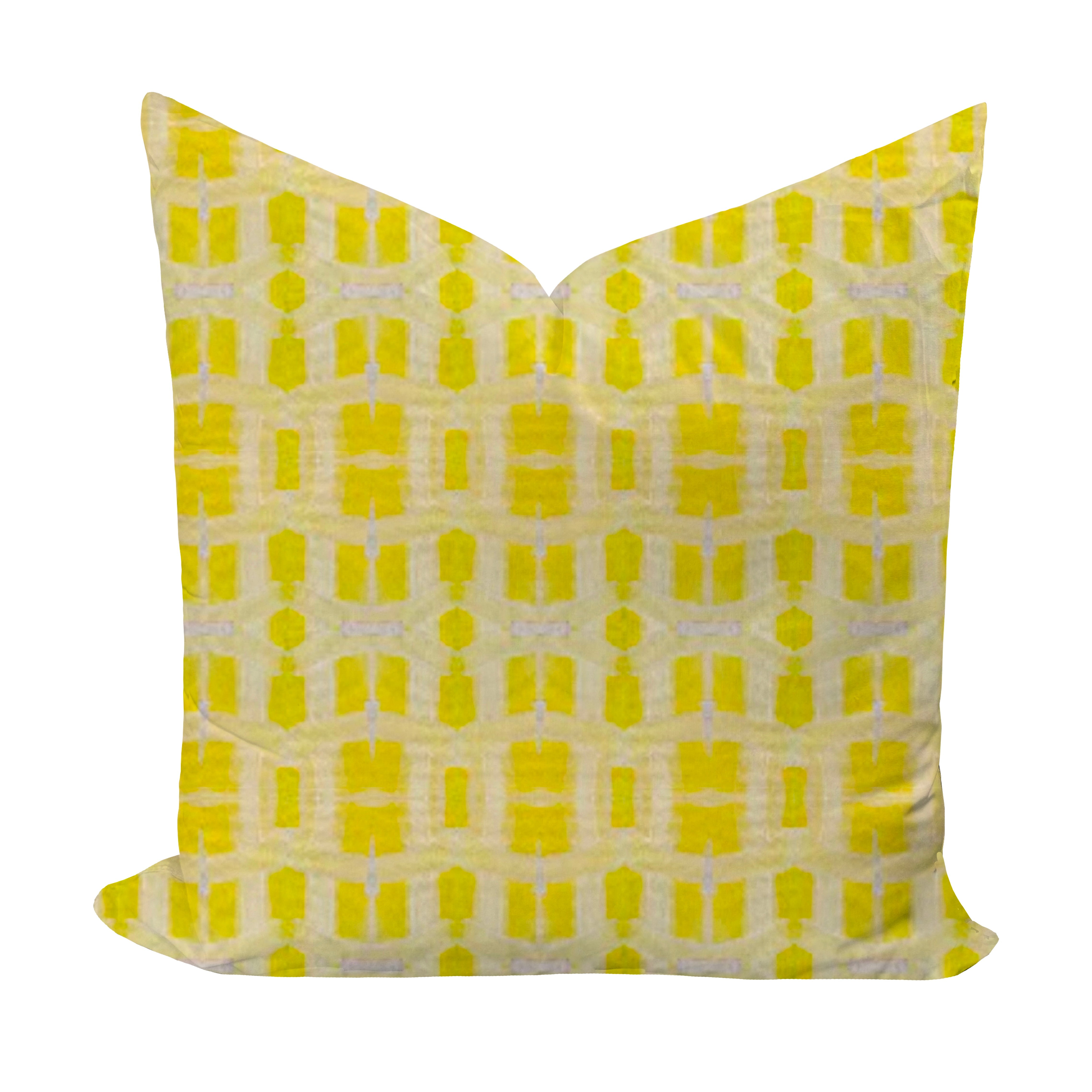 Yellow geometric patterned pillow on a white background