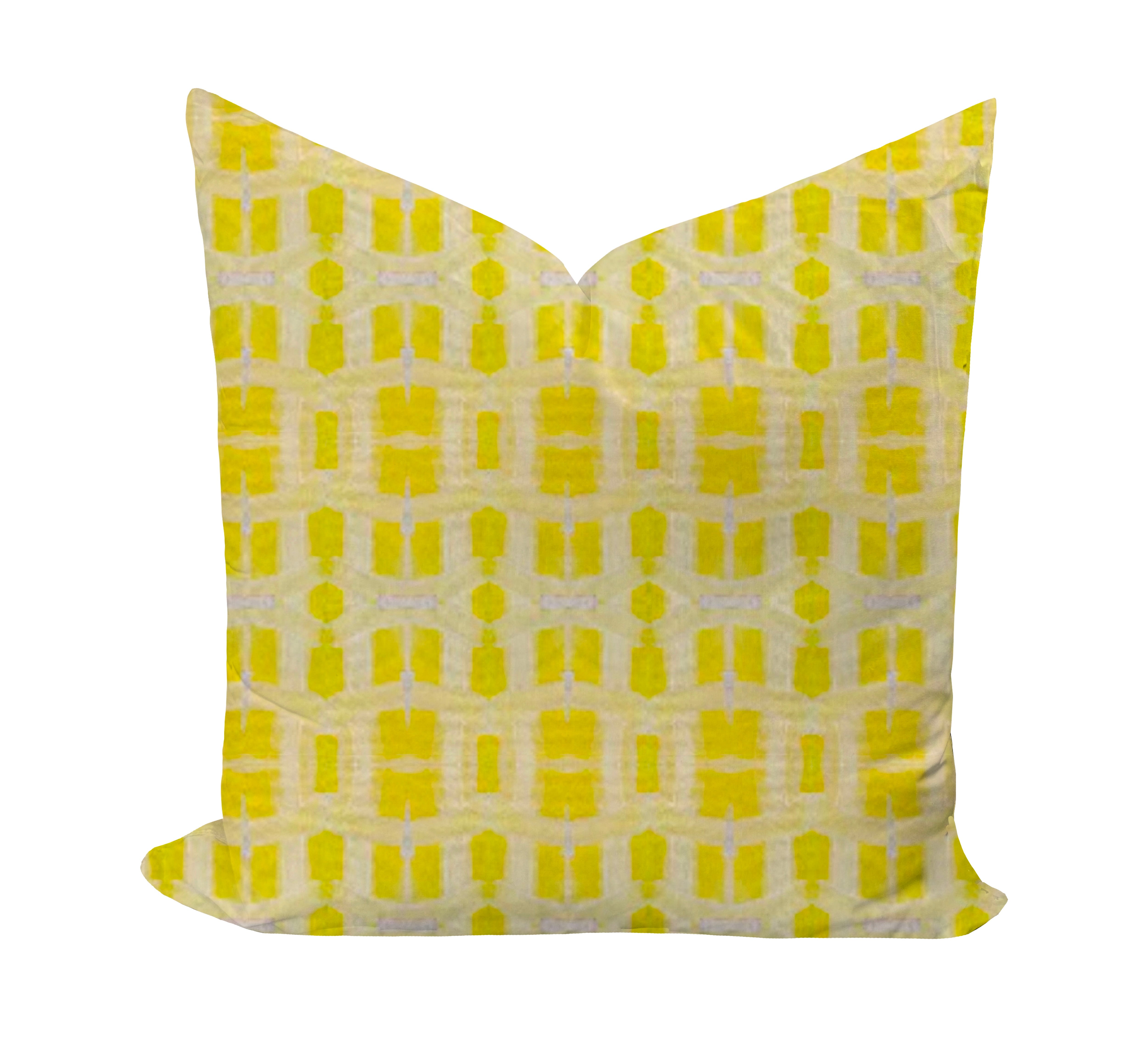 Yellow geometric patterned pillow on a white background
