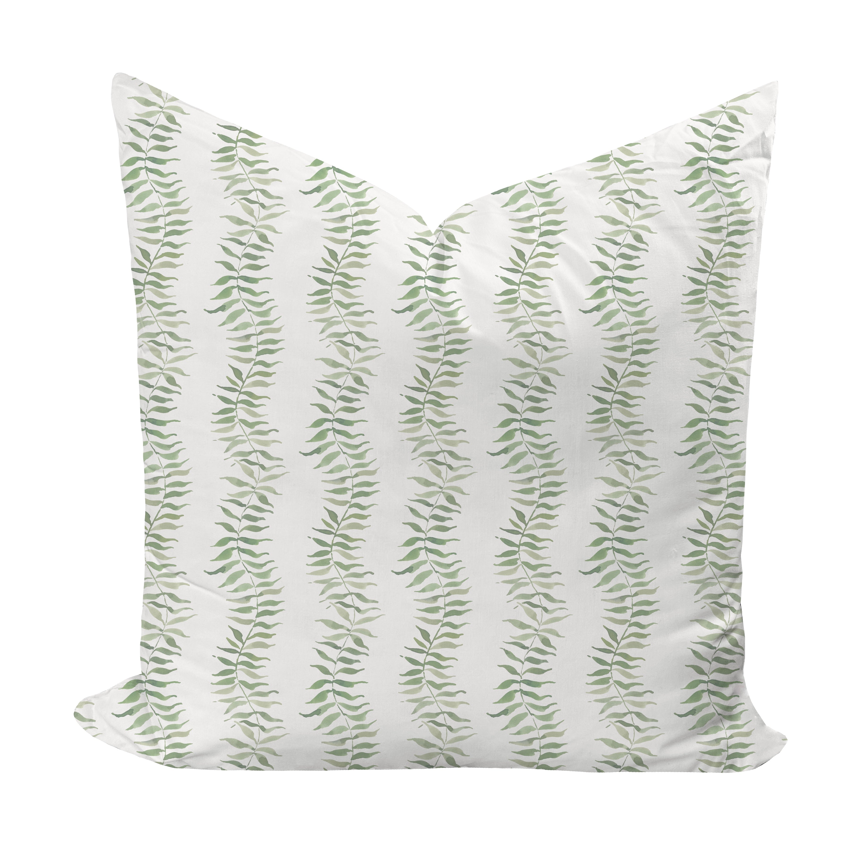 Decorative pillow with green leaf pattern on a white background