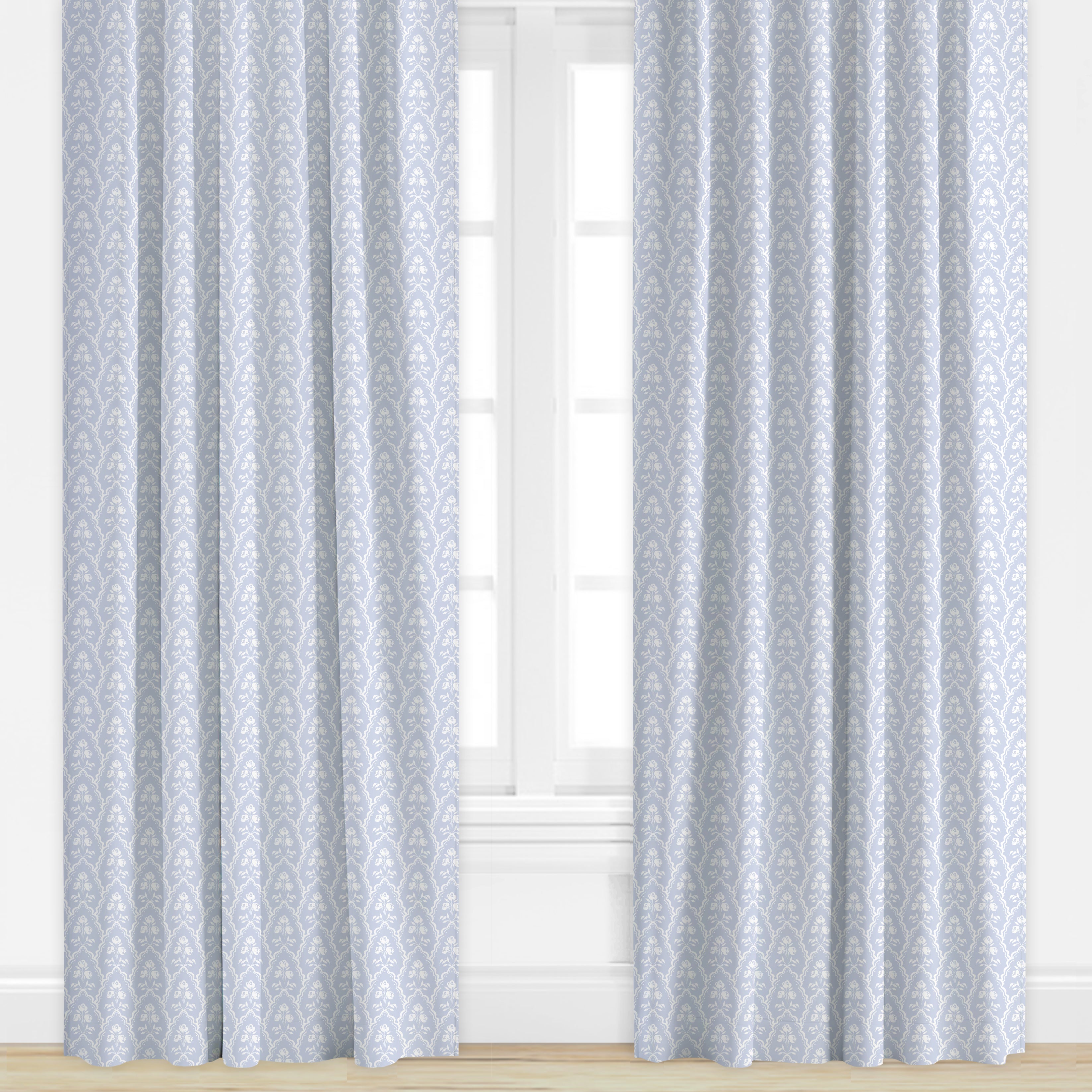Floral Patterned curtains in periwinkle on a window with a light background