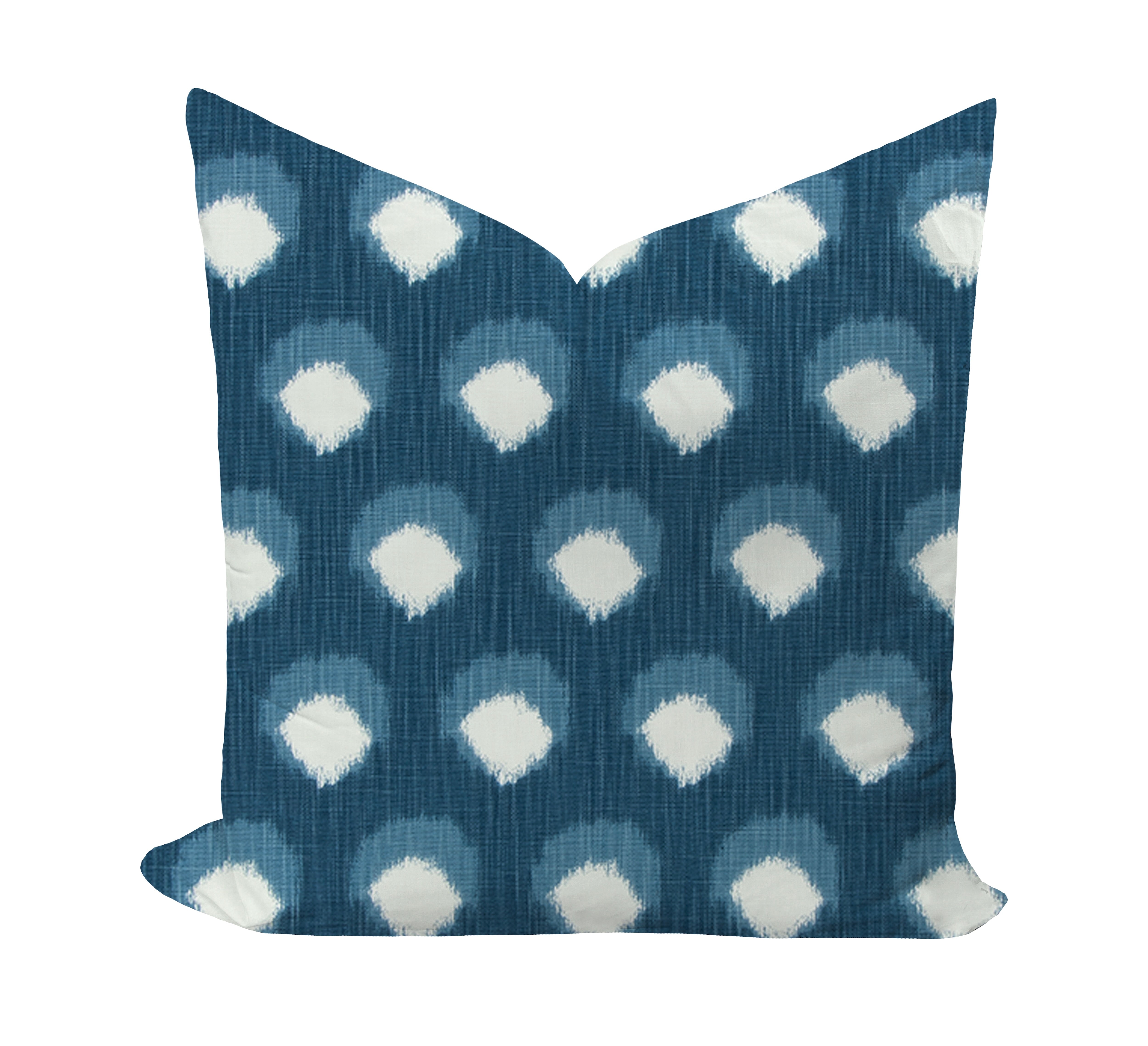 Decorative pillow with blue and white polka dot pattern on a white background