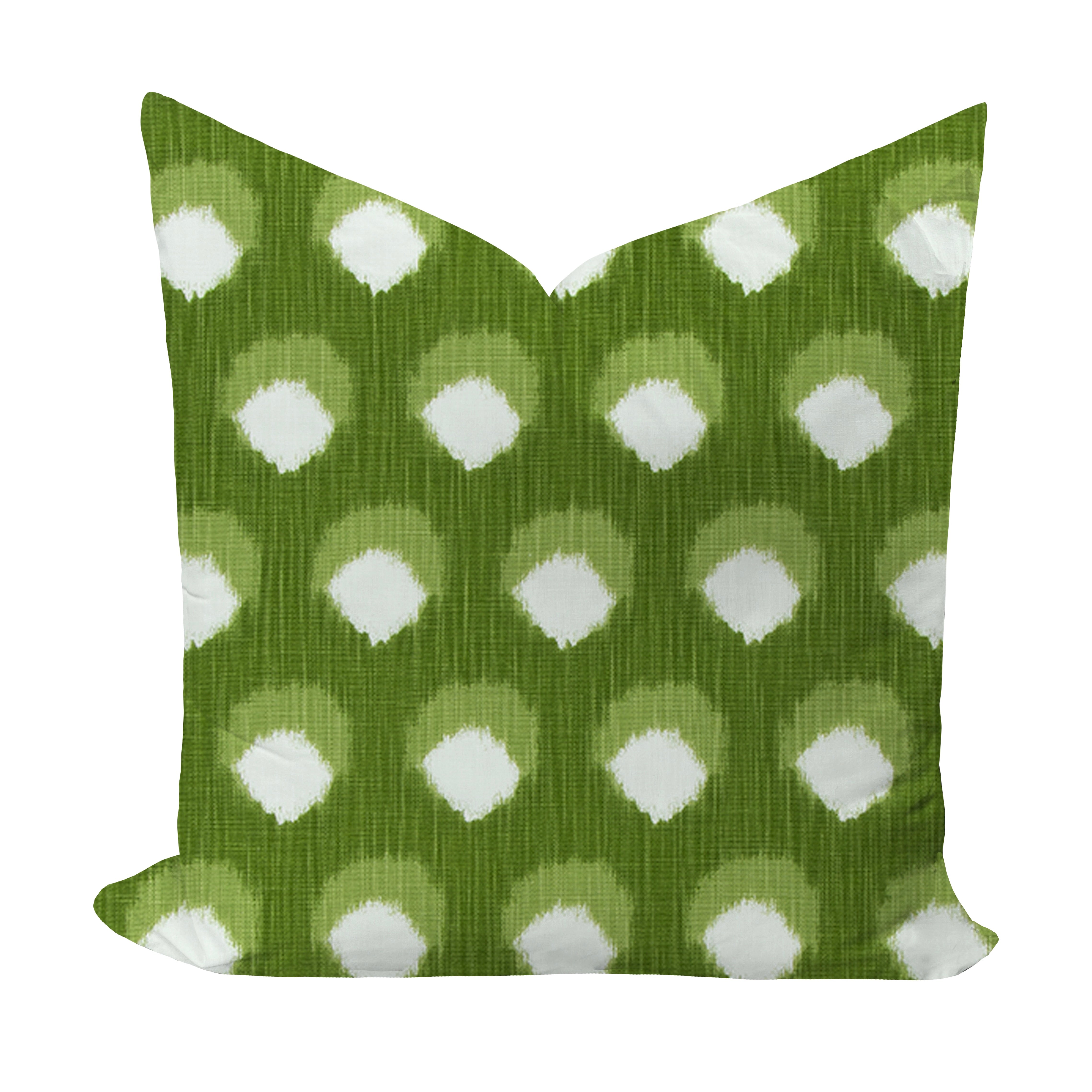 Green pillow with white polka dot pattern on a white background