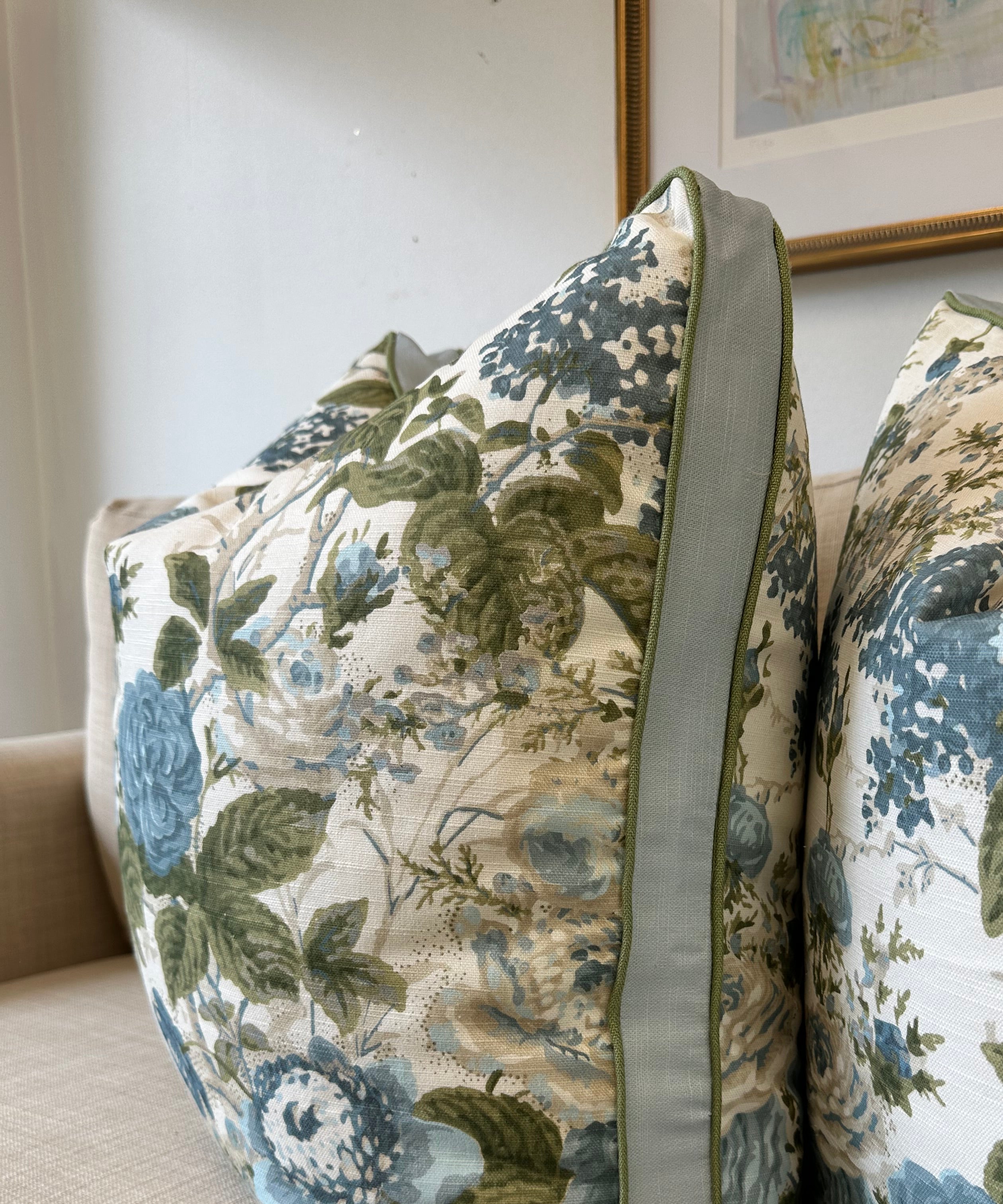 Floral-patterned pillow cover in blue and green.