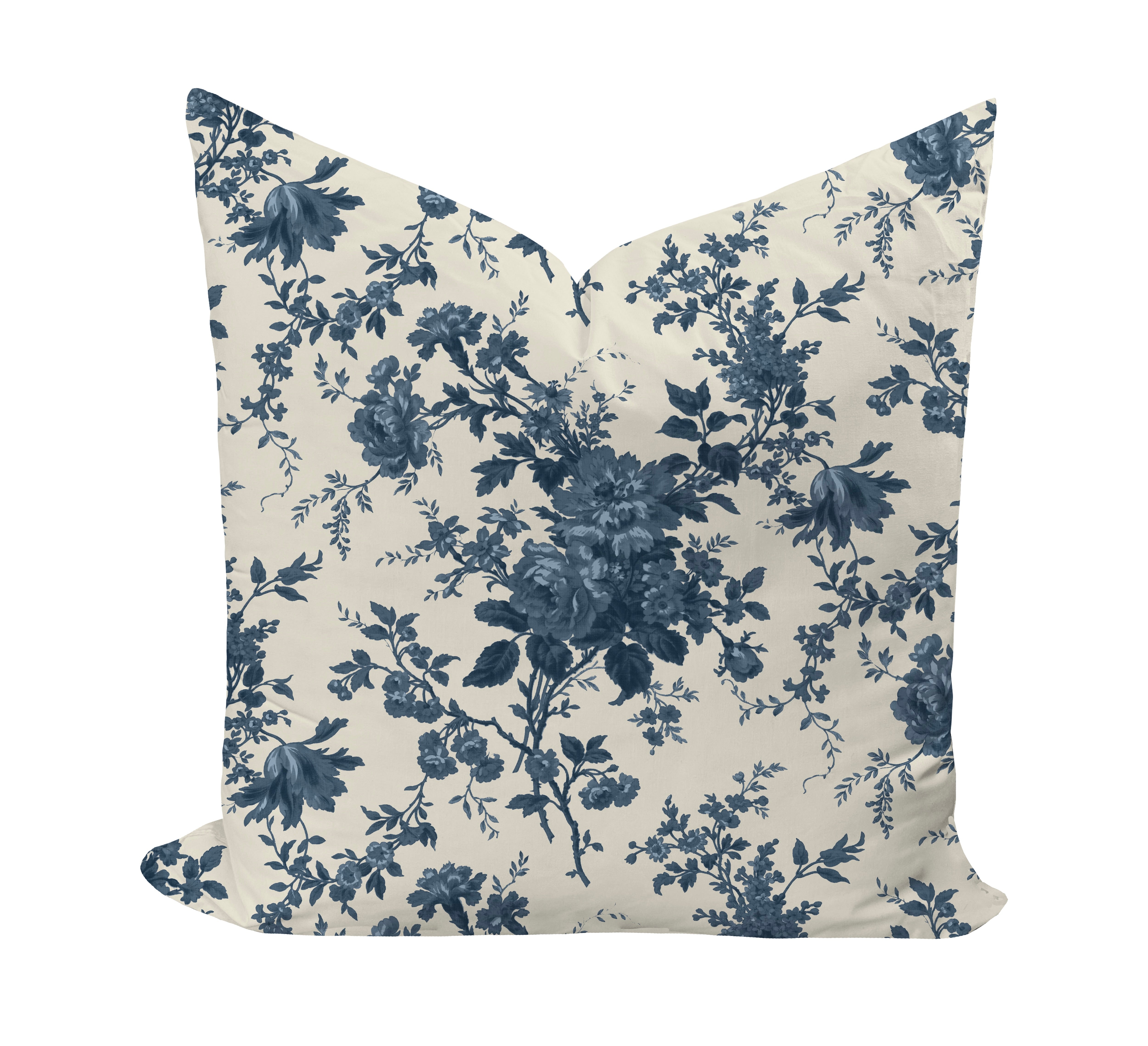 Floral patterned pillow with blue flowers on a beige background