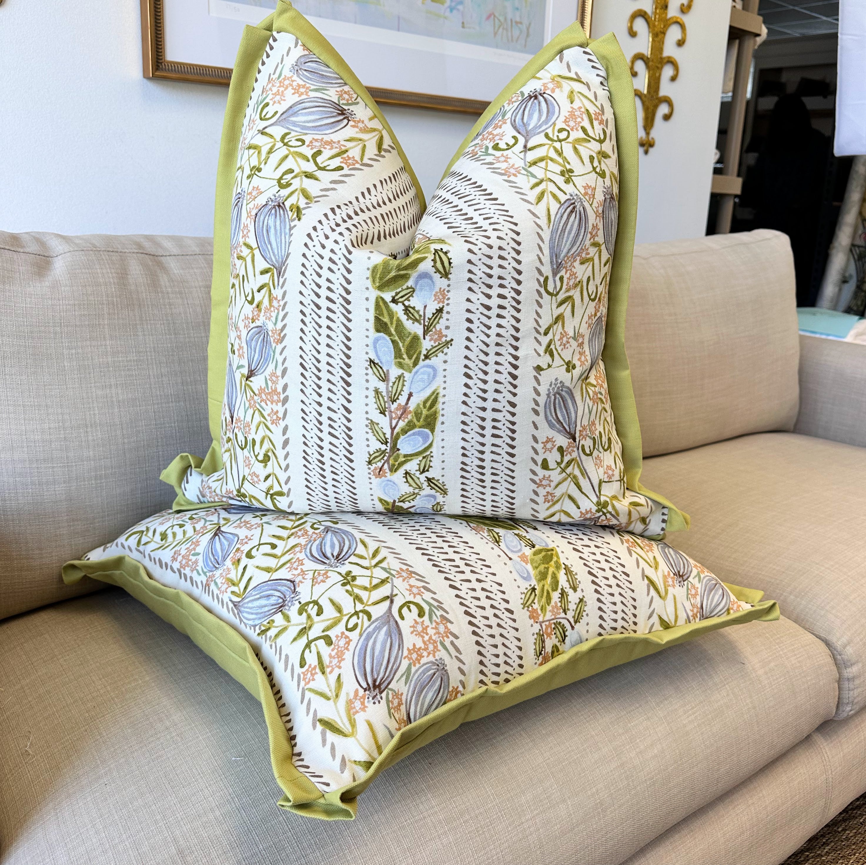 Decorative pillows with floral pattern on a beige sofa