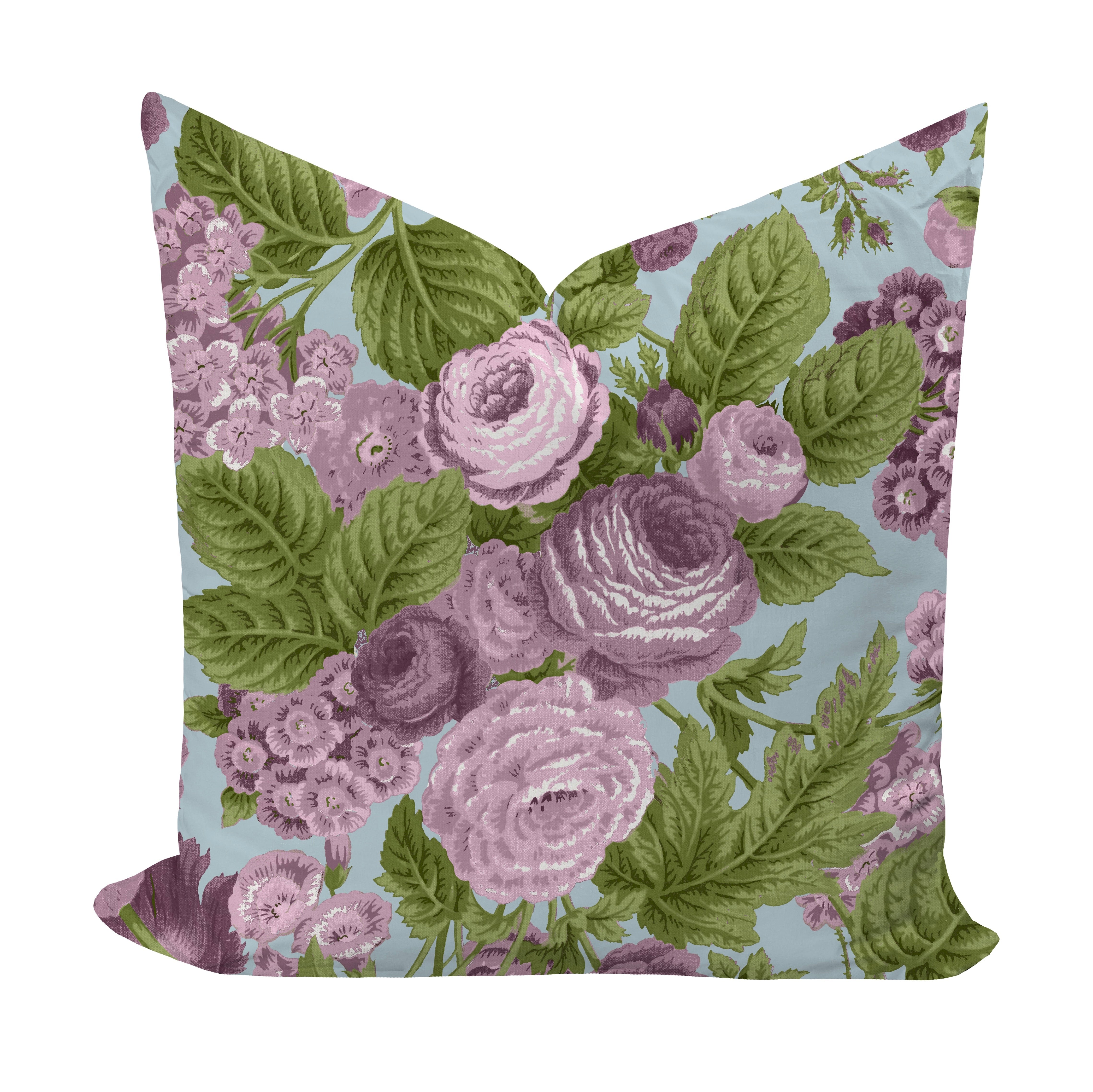 Floral pillow with purple roses and green leaves on a light blue background
