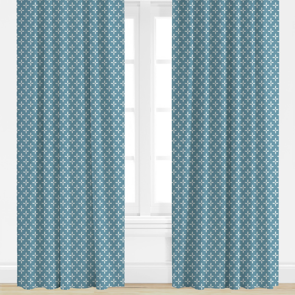 Pair of blue patterned curtains on a window with a white background