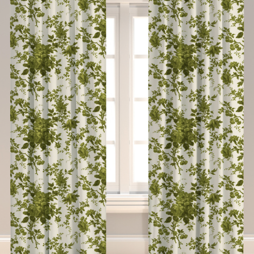 A set of green leaf patterned drapery panels hanging on a window, with a visible pleated design and lining.