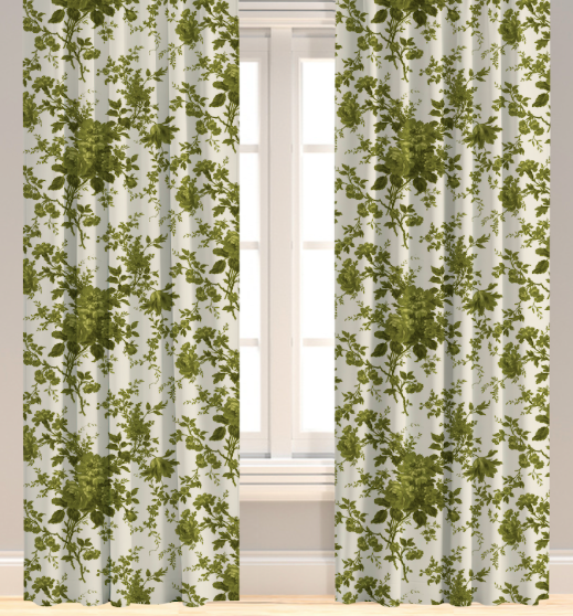 A set of green leaf patterned drapery panels hanging on a window, with a visible pleated design and lining.
