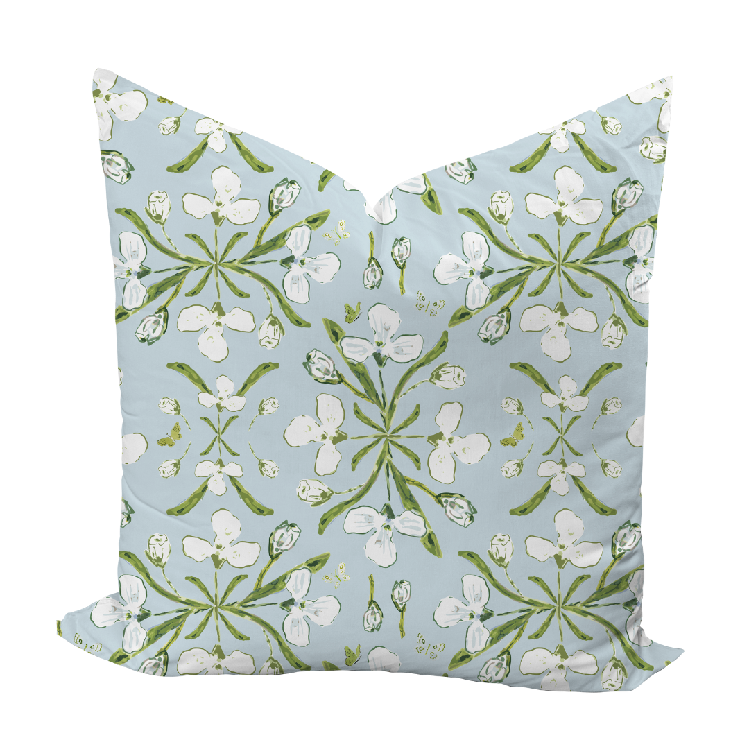 Decorative pillow with floral pattern on a light blue background