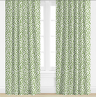 Green patterned curtains on a white window with a light background