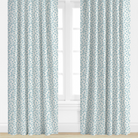 Blue Patterned curtains on a window with a light background