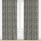 Black and white patterned curtains on a window with a white background