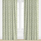 Green patterned curtains on a white window with a light background