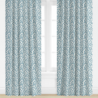 blue Patterned curtains on a window with a white background