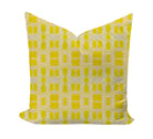 Yellow geometric patterned pillow on a white background