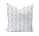 Decorative pillow with blue leaf pattern on a white background