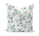 Floral patterned pillow with birds and butterflies in blue