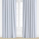 Floral Patterned curtains in periwinkle on a window with a light background