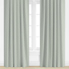 Patterned curtains in blue by Camilla Moss on a window with a light background