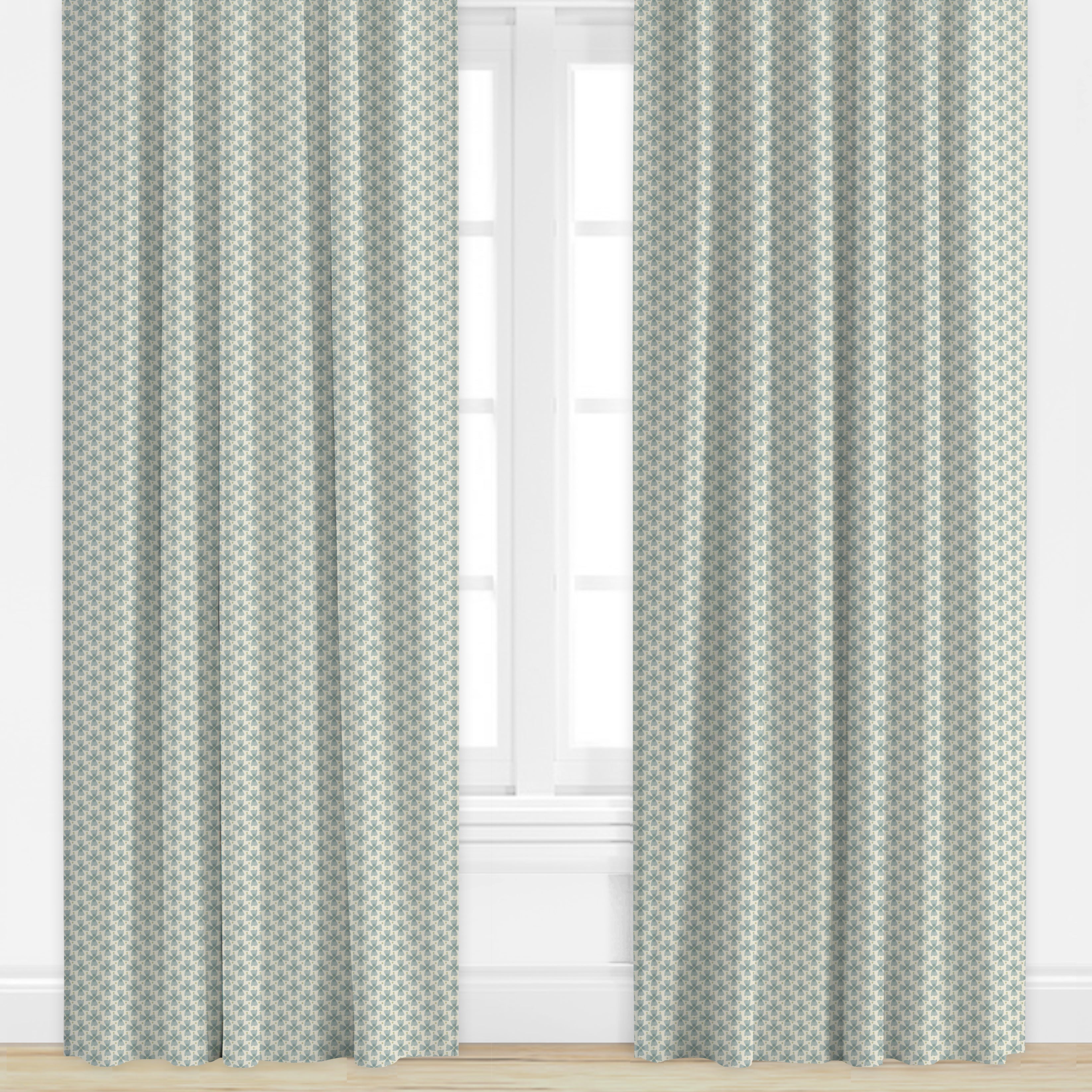 Patterned curtains in blue by Camilla Moss on a window with a light background