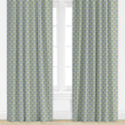 Pair of blue curtains with floral pattern in front of a window.