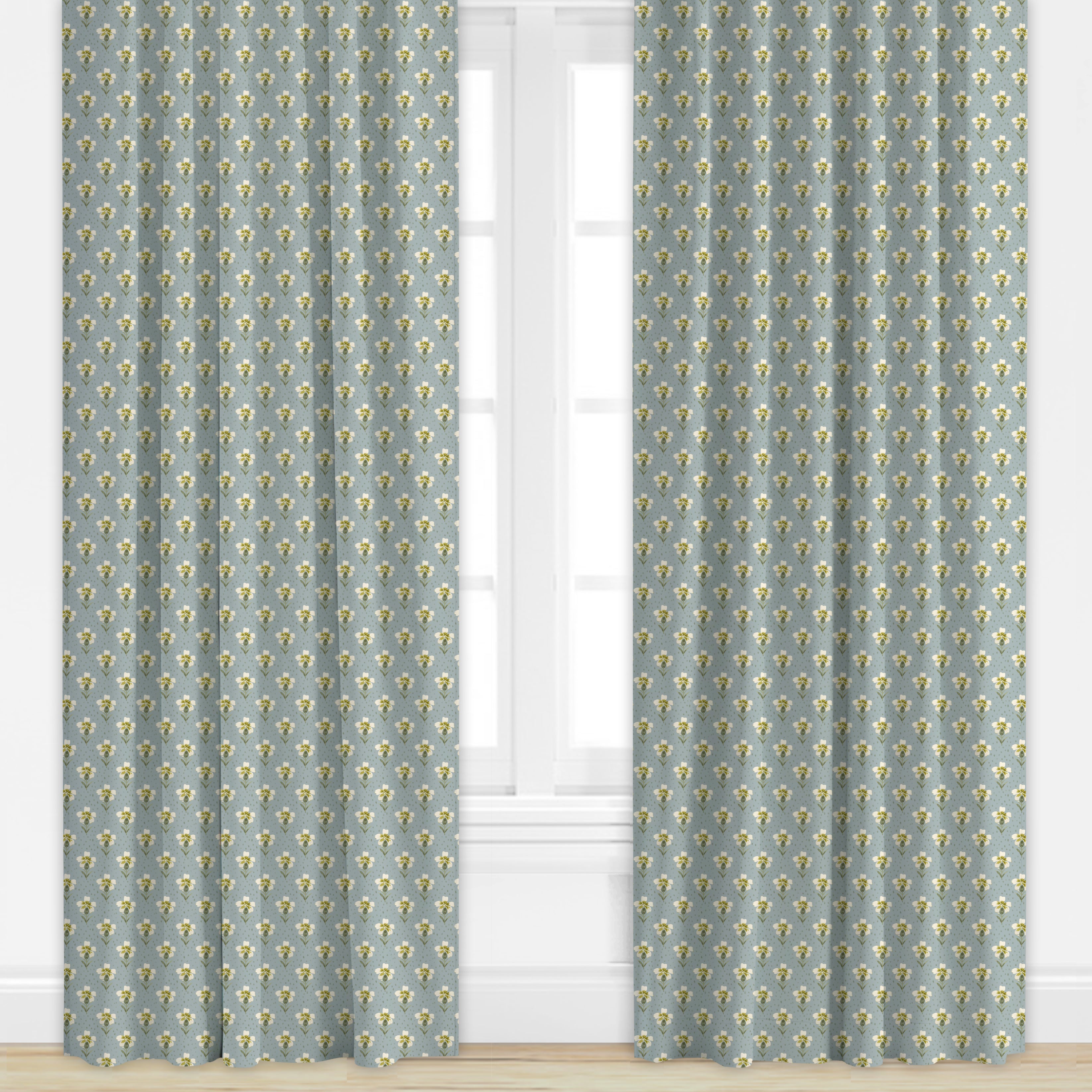 Pair of blue curtains with floral pattern in front of a window.