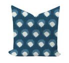 Decorative pillow with blue and white polka dot pattern on a white background