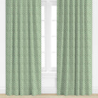 Green patterned curtains on a white window frame