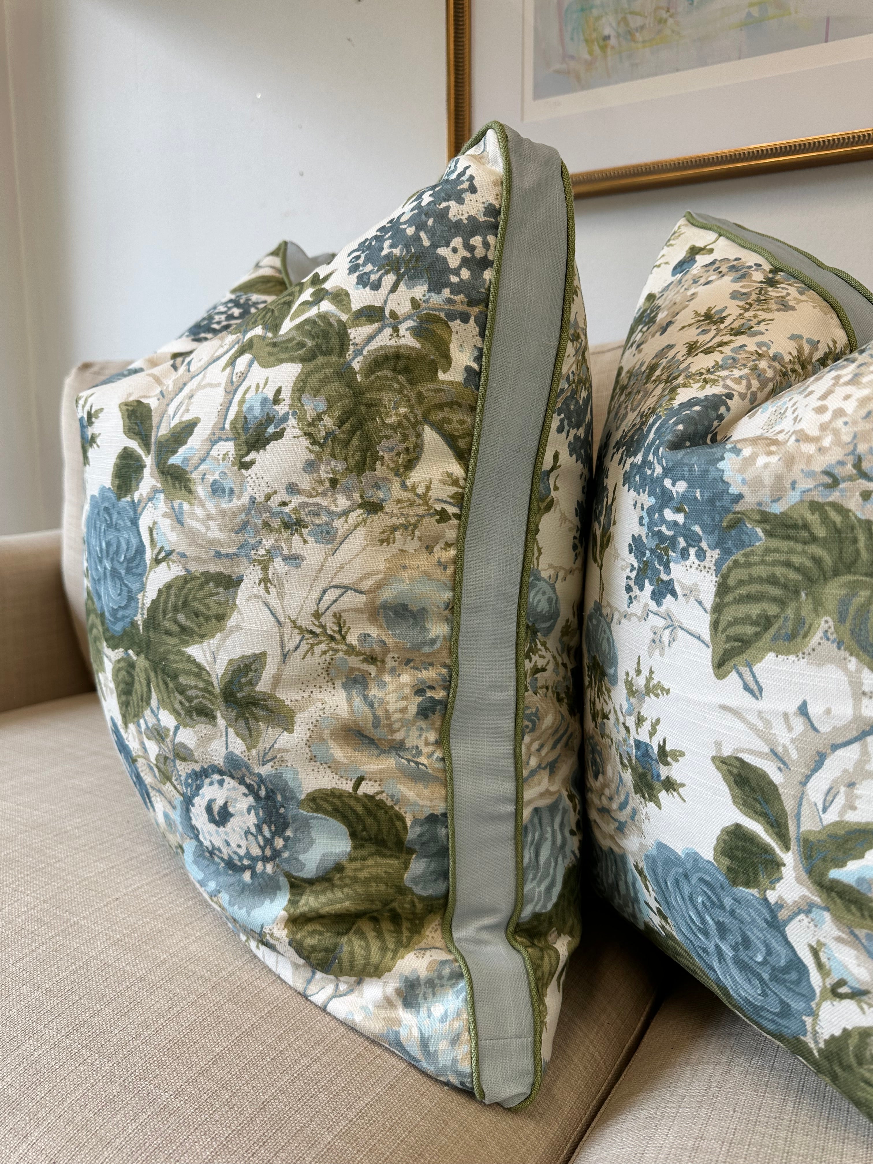 Floral-patterned pillow cover in blue and green.