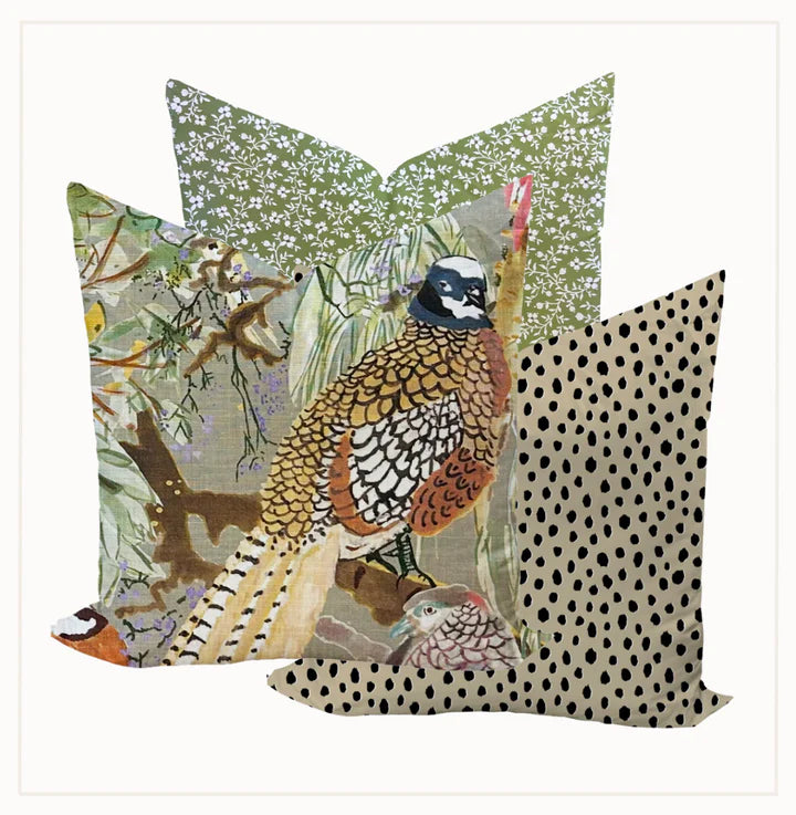 Decorative pillows with bird and nature-themed patterns on a white background