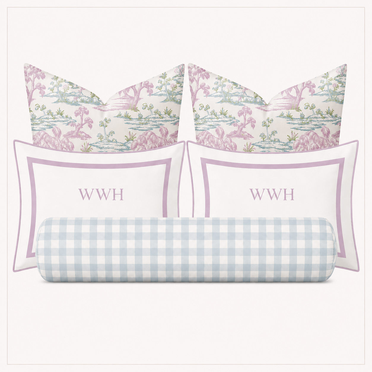 A bedding set of four pillows on a light gray background: two square pillows with a pink and green botanical toile pattern, two rectangular white pillows with a lavender border and the monogram 'WWH' in lavender, and one cylindrical lumbar pillow in a light blue and white gingham pattern.