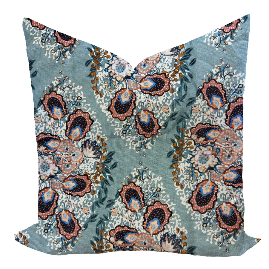 Decorative pillow cover with a floral design in a colonial blue color on a linen background, featuring a solid back.