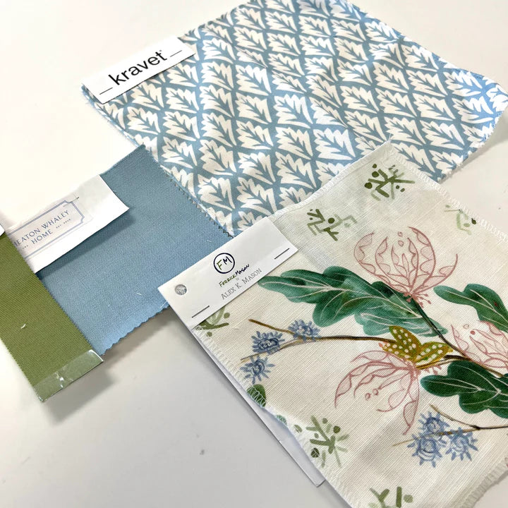 Fabric swatches with patterns and labels on a white surface