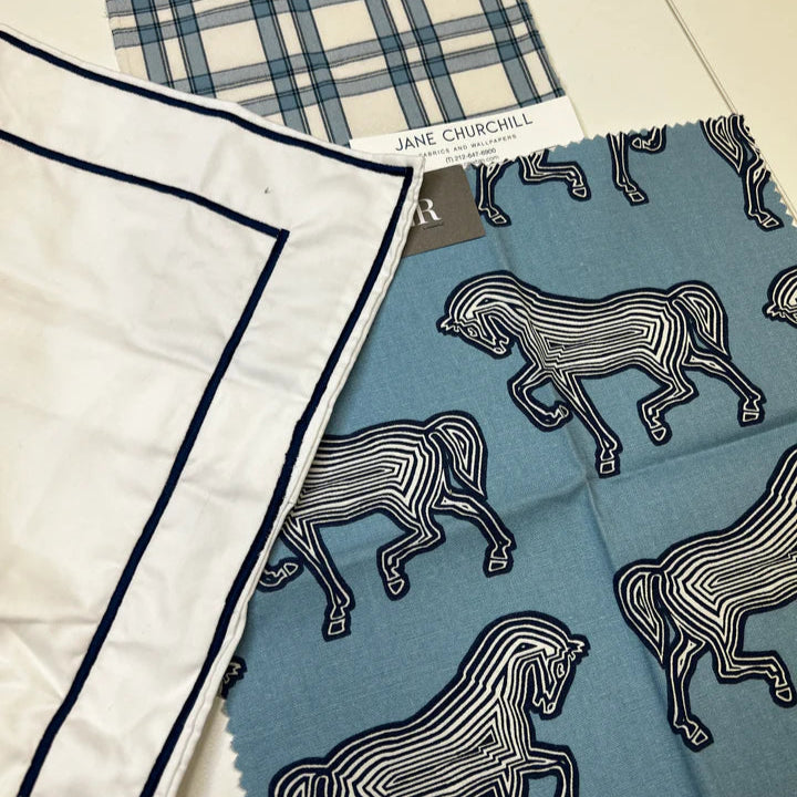 Two fabric samples with different patterns on a flat surface.