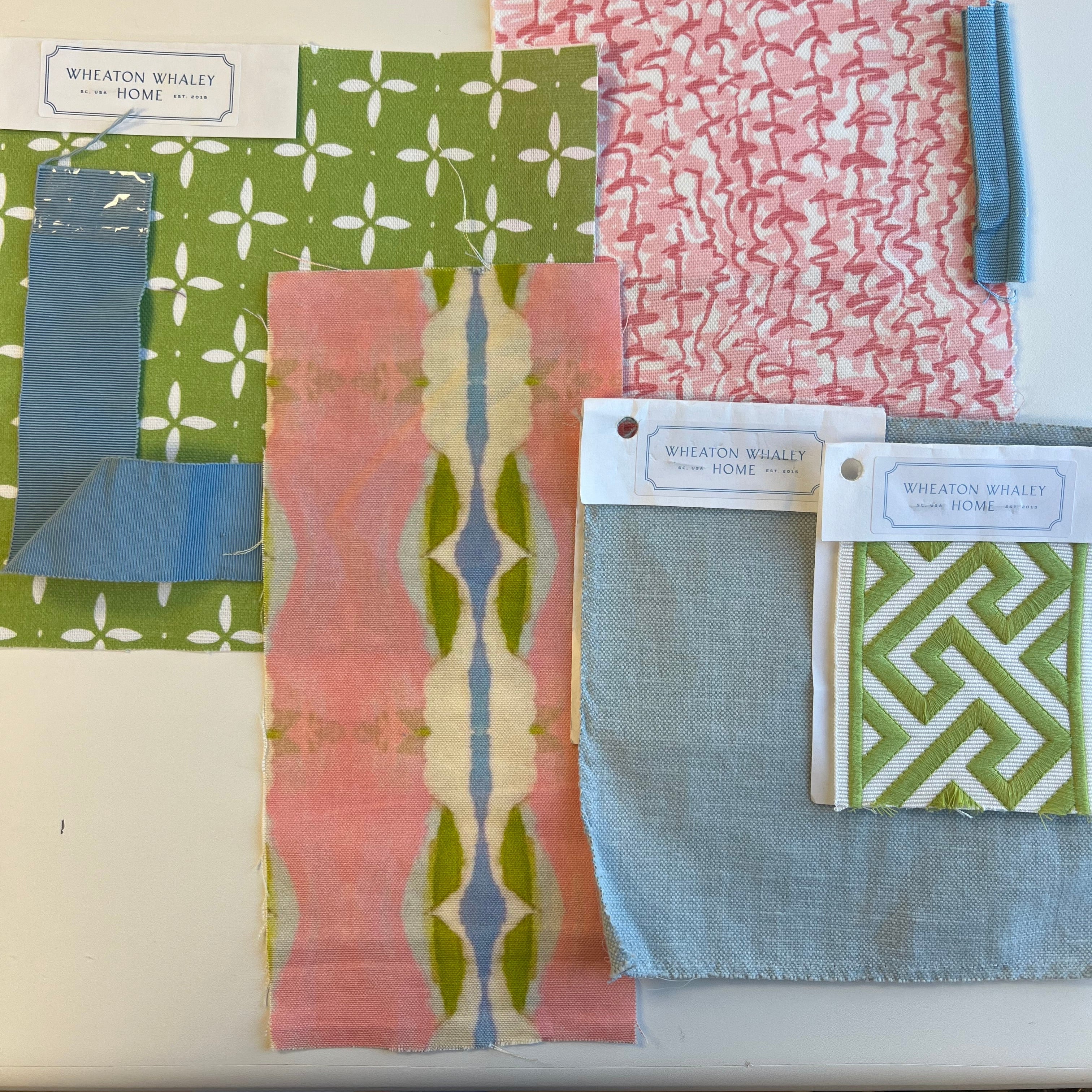 Collection of patterned fabric swatches with visible brand labels on a white surface.