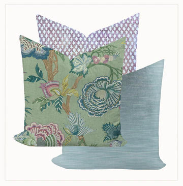 Three decorative pillows with different patterns on a white background