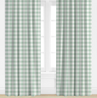 Blue Green and white checkered curtains on a window with a white wall background