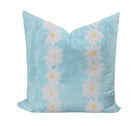 Decorative pillow with daisy pattern on a light blue background
