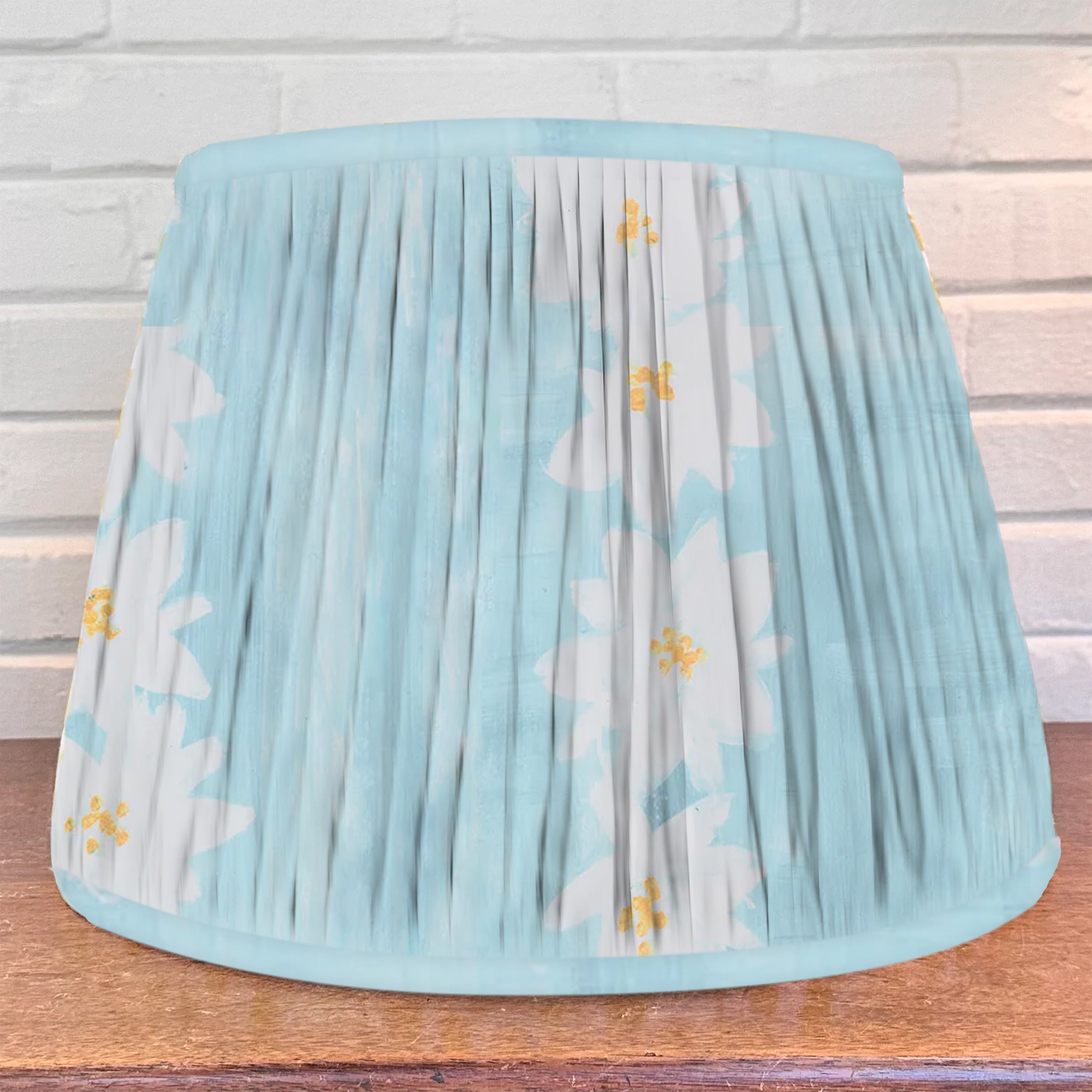 Blue Floral patterned lampshade on a wooden surface 