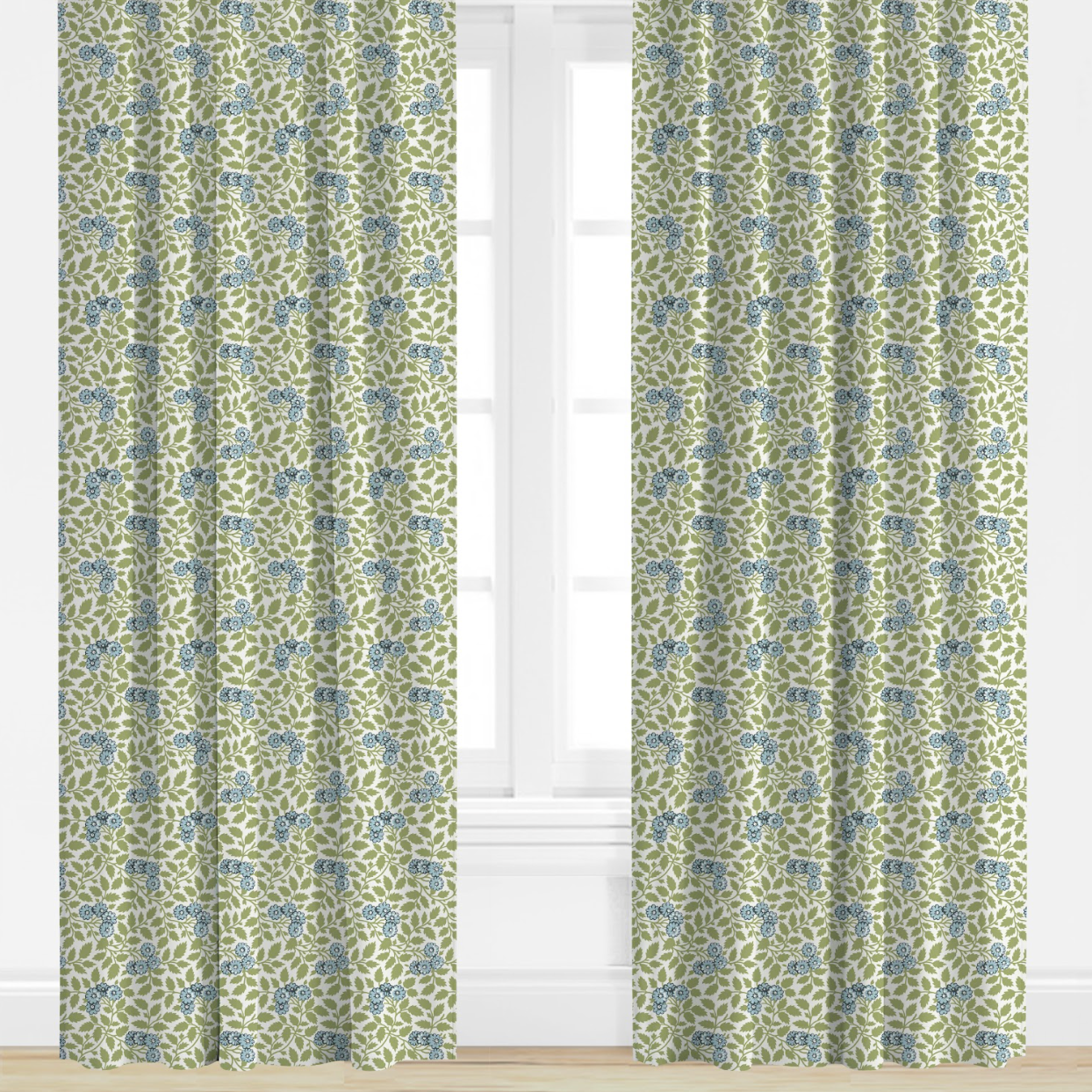 Pair of green curtains with green and blue floral pattern in a room with white walls and floor.