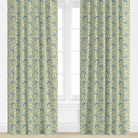 Pair of green curtains with green and blue floral pattern in a room with white walls and floor.