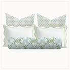 Set of decorative pillows with floral patterns in green and blue on a white background