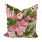 Floral pillow with pink roses and green leaves on a light background