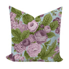 Floral pillow with purple roses and green leaves on a light blue background