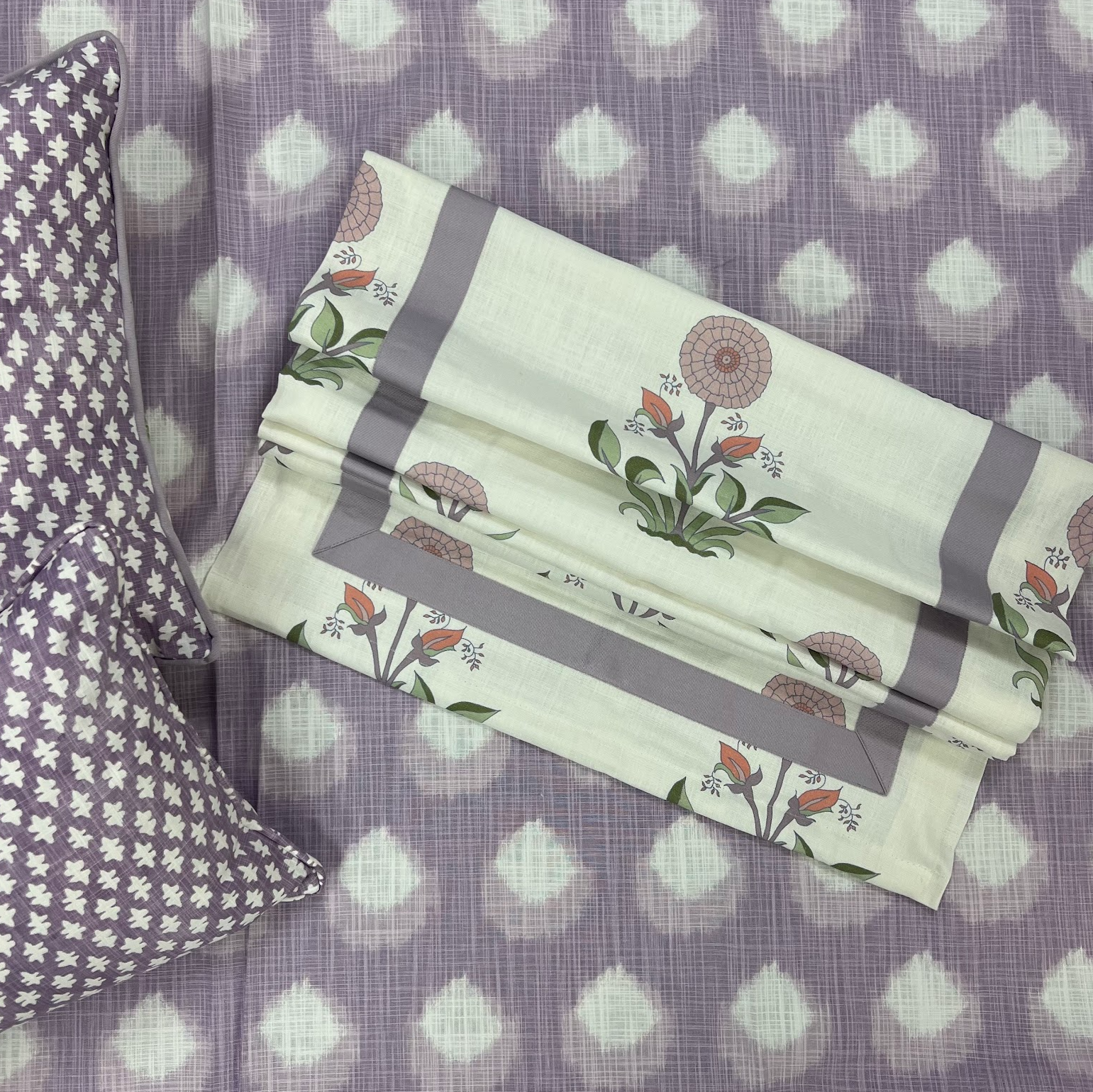 Floral-patterned fabric on a purple polka dot background