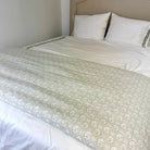 Floral block print bed footer in light tan