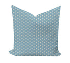 A square throw pillow featuring a light blue background with a repeating pattern of small white stars and geometric lines, shown against a plain white background.