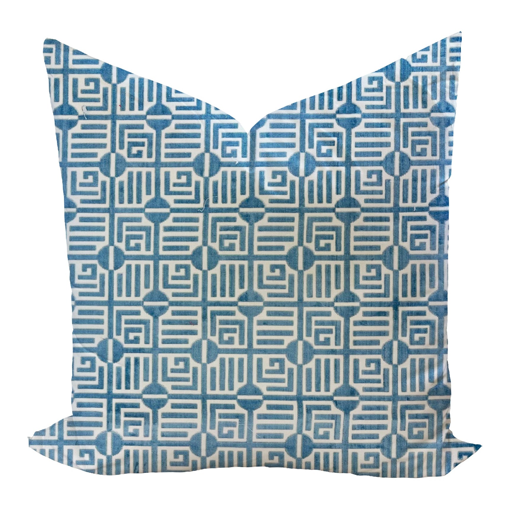 Decorative pillow with blue geometric pattern on a white background
