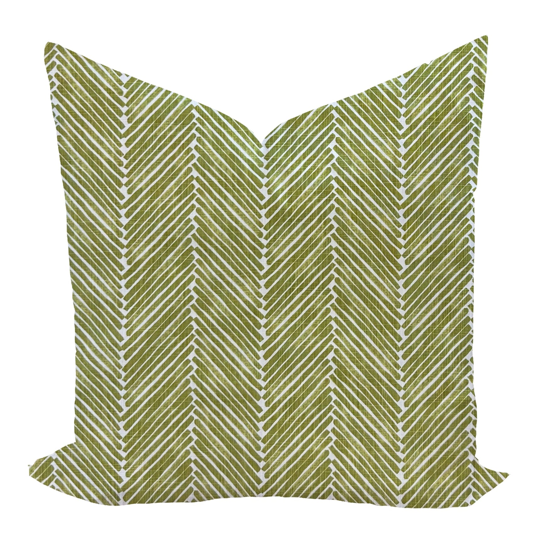 Green pillow with white zigzag pattern on a white background